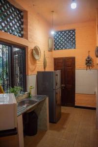 a kitchen with a stainless steel refrigerator and a sink at Leibe Lake Holiday Villa in Wennappuwa