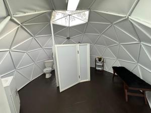 an inside view of a dome room with a toilet and a door at Glamping El Encanto in Zapopan