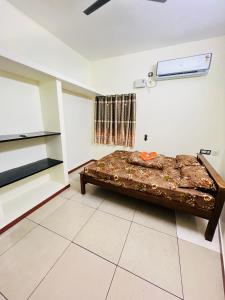 a bedroom with a bed in a room at Lumina Home Stay in Puducherry