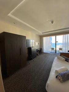 a hotel room with two beds and a large window at Ocean View Studio Apt - Surfer's Paradise in Gold Coast