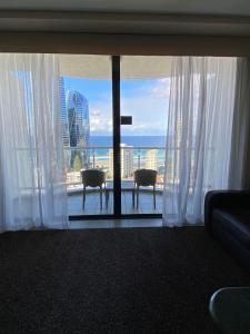 a room with a view of the ocean from a hotel room at Ocean View Studio Apt - Surfer's Paradise in Gold Coast