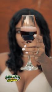 a woman holding up a glass of red wine at Glamping El Encanto in Zapopan
