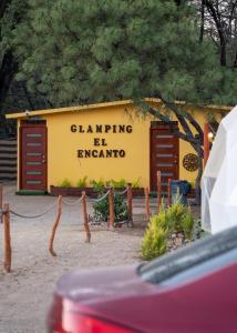 a yellow building with the words dancing be enigma at Glamping El Encanto in Zapopan