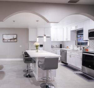 a kitchen with white cabinets and a table with chairs at The pearl Island2 in Davenport