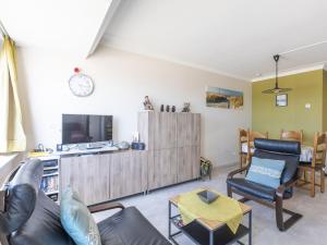 A television and/or entertainment centre at Apartment with sea view and shared pool