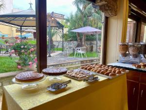 a table with cakes and pastries on top at Hotel Garibaldi in Milazzo