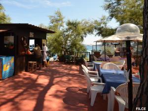 a group of tables and chairs with a blue table cloth at Residence Capobianco in Portoferraio