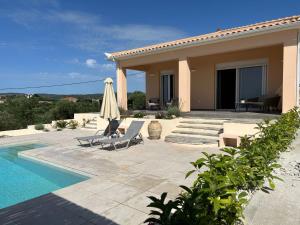 a villa with a swimming pool and a house at Villa Vounaria in Vounaria