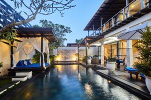 an external view of a villa with a swimming pool at Temple Hill Residence Villa in Jimbaran