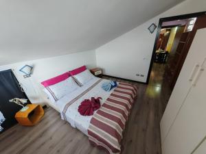 a bedroom with a bed with a striped blanket at Piccolo paradiso in Viadana