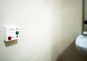 a bathroom with a soap dispenser on the wall at Elixír Panzió in Nyírbátor +52 photos