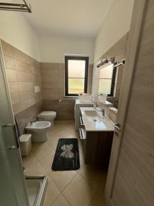 a bathroom with a sink and a toilet and a window at DENIA'S HOME in SantʼEufemia Lamezia +33 photos