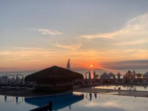 a sunset over a resort with a pool of water at Happy kids' vacation home in Lozenets