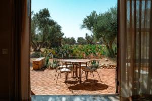 a patio with a table and chairs and a garden at Hábimo - Valle de Guadalupe in Valle de Guadalupe +19 photos
