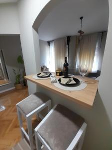 a kitchen with a table with a wine bottle and glasses at HARMONY in Žarkovo