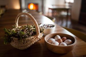 a basket of eggs and a basket of nuts on a table at Agriturismo Piane in Ono Degno