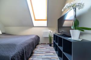 Posteľ alebo postele v izbe v ubytovaní Buzavirág Apartman