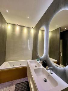 a bathroom with a sink and a mirror at GRG Charme Apartment in Milan +27 photos