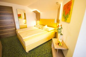 a hotel room with a bed and a table at Gästehaus Stabauer in Mondsee