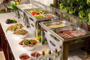 a buffet line with many different types of food at Poykent Naqshband in Bukhara
