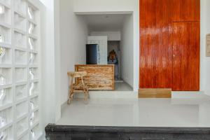 a kitchen with a wooden door and a chair at Belvilla 93868 Hii Inn in Uluwatu