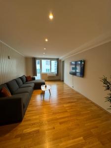 a living room with a couch and a table at Charming 3-Bedroom Apartment in the Heart of Kristiansund in Kristiansund