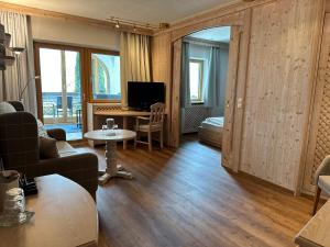 a living room with a couch and a table at Hotel Restaurant Neu Meran in Bad Reichenhall