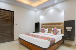 a bedroom with a large bed in a room at FabHotel Classic in Bhopal