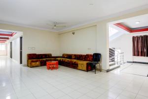 a living room with two couches and a table at FabHotel Classic in Bhopal