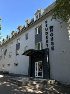 a hotel with a sign on the front of it at Student Castle Almaty hostel in Almaty
