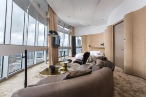 a living room with a couch and a bed at Vilnius TV Tower Apartments DEBESYS in Vilnius