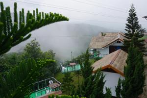 a view of a house in the mountains with trees at Baan Chomdao Phu Thap Buek in Phetchabun
