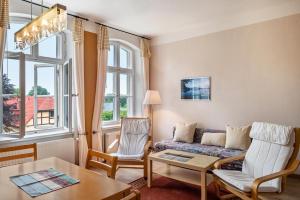 a living room with a couch and a table at Herrenhaus Marienhof in Krakow am See