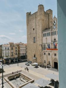 a large stone building with a clock tower at Domus Via Domitia in Narbonne