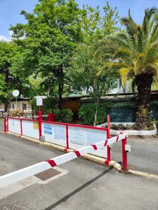 a red and white barrier on the side of a road at Campeggio La Quiete in Marina di Massa