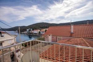 a balcony with a view of a river and buildings at Apartments Tončica in Božava