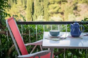 a table and chairs with a blue pitcher and a cup at Apartments Maria in Cavtat