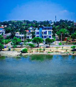 a group of houses next to a body of water at Trinco Lagoon in Trincomalee