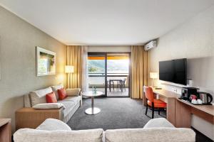 TV a/nebo společenská místnost v ubytování H4 Hotel Arcadia Locarno