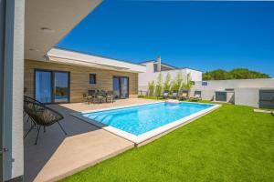 a swimming pool in the backyard of a house at Villa Aura in Pula