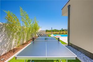 a ping pong table in the backyard of a house at Villa Aura in Pula