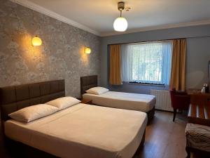 a hotel room with two beds and a window at Lonca Butik Hotel in Giresun