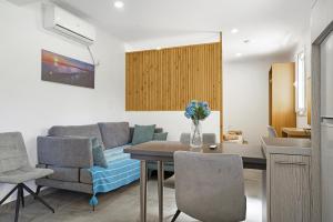 a kitchen and living room with a table and chairs at Casa Della Nonna in Argostoli
