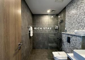 a bathroom with a shower and a toilet and a sink at Harmonious 3BR in Stella Maris, Sea View, Marina in Dubai