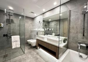 a bathroom with a sink and a toilet and a shower at Harmonious 3BR in Stella Maris, Sea View, Marina in Dubai