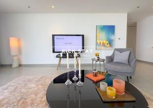 a living room with a table and a chair at Harmonious 3BR in Stella Maris, Sea View, Marina in Dubai