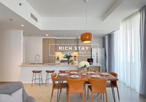 a dining room with a wooden table and chairs at Harmonious 3BR in Stella Maris, Sea View, Marina in Dubai