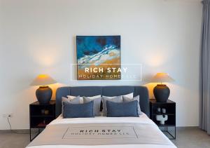 a bedroom with a bed with two lamps and a painting at Harmonious 3BR in Stella Maris, Sea View, Marina in Dubai