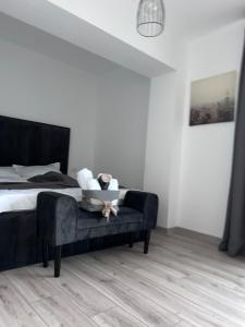 a bedroom with a bed with a black headboard at APARTAMENT PANORAMIC in Alba Iulia