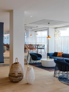 a living room with a couch and chairs and a table at Oceania Saint Malo in Saint Malo